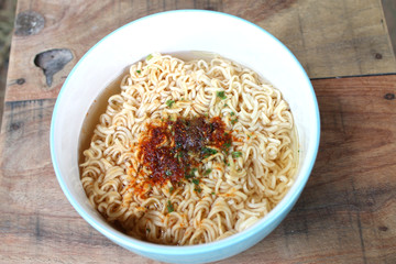 instant noodles  in blue bowl on the wooden background.