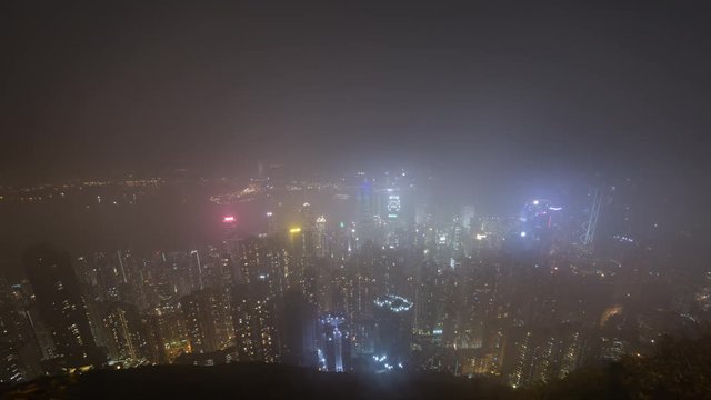 Foggy night of Victoria Harbour from The Peak in Hong Kong