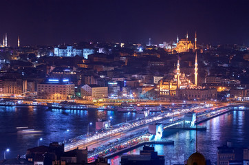 Fototapeta na wymiar Istanbul's old city at night, with Galata Bridge in the foreground, and the Hagia Sophia and Blue Mosque
