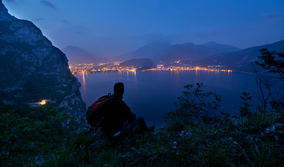 Young men admiring the Garda Lake,Beautiful landscape. Vight vision of Lake Garda, Riva del Garda,Italy. Popular destinations for travel in Europe.focus on the city