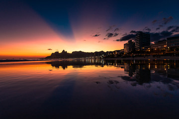 View of Sunset in Ipanema Beach, With Rays of Sun in the Sky, Reflecting in Water