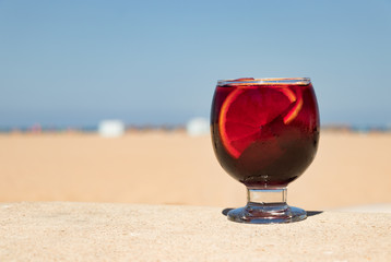 A sangria drink with a beach background.