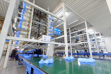 Workers in the PVC gloves production lines in a factory