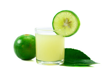 Glass of lime juice with lime half isolated on white background.
