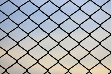 Steel mesh fence with beautiful sky background