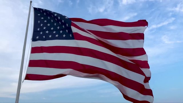 A huge American Flag flying in the wind in 4k