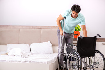 Young handsome disabled man recovering at home 