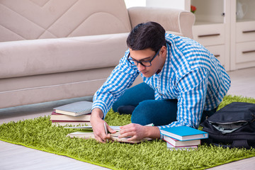 Young student preparing for exams at home