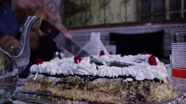 Big Happy Birthday Cake with chocolate cutted in pieces