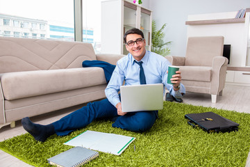 Businessman taking work home and working overtime