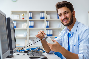 IT technician looking at IT equipment
