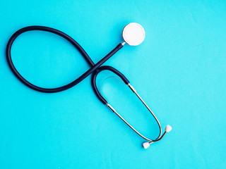 stethoscope on blue background copy space