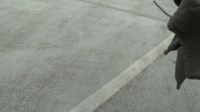 A Hoody is falling on a grey concrete floor