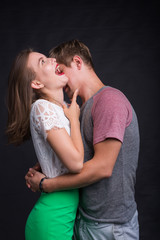 Passionate young people in love on black background