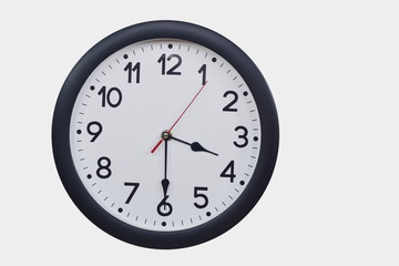 Time concept with black clock at  half past three