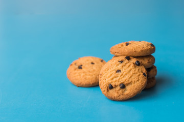 Chocolate chip cookies stack on blue background