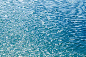 Shining blue wavy water surface ripple background