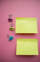 Сolorful blank sticky note or empty post notes with office clamps on pink background