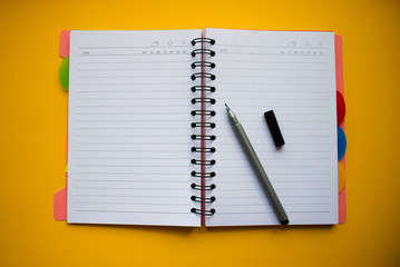 Сolorful blank sticky note or empty post notes with office clamps and notebook on yellow background