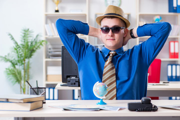 Young employee preparing for vacation trip 