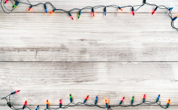 Christmas lights bulb decoration on white wood plank. Merry Christmas and New Year holiday background. vintage color tone.