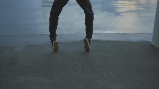 Urban female dancer dance hip hop styles and smiling on a roof top. slowmotion handheld shot