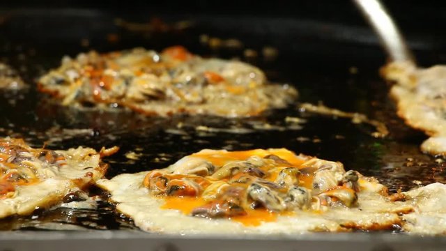 Frying  oyster omelette in pan, Thai street food