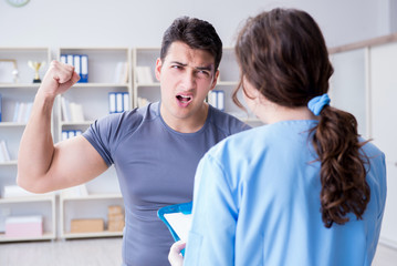 Young man visiting female traumatologist with black eye 