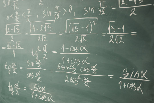 Algebra, mathematics. Trigonometry and elementary functions written on the chalkboard.