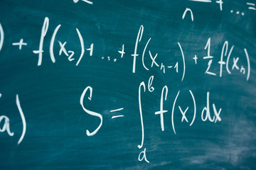 Mathematics function integra formulas written by chalk on the chalkboard.