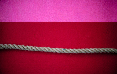 Rope on multicolored red and pink background