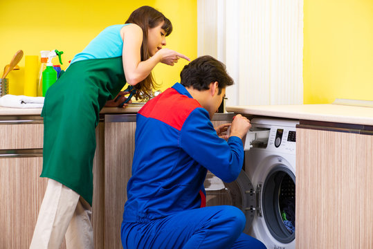 Contractor repairing washing machine at home
