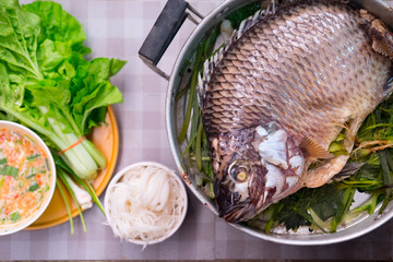 Close up Tilapia fish with sauce and vegetables