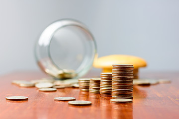 Close up Sort the coins sixth from the jar on the table..