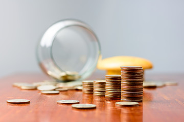 Close up Sort the coins sixth from the jar on the table..
