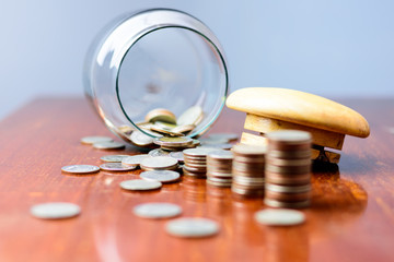 Close up Sort the coins sixth from the jar on the table..
