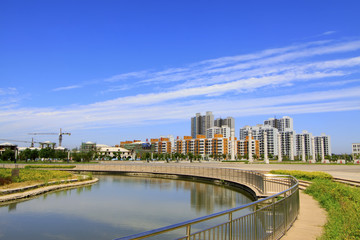 Naklejka premium Wide water surface and high rise buildings