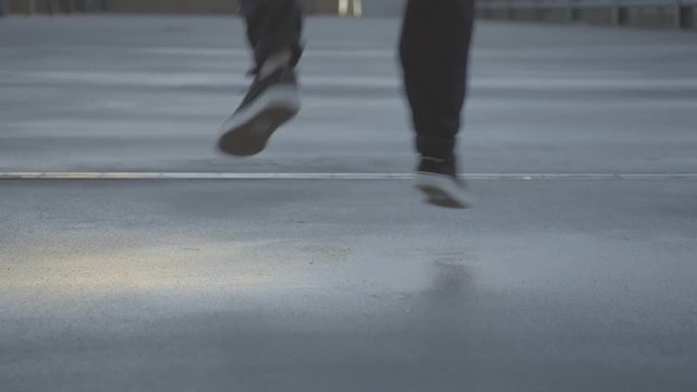 Young Girl dances hip hop on a wet concrete street