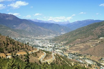 Fototapeta na wymiar Winding or curved asphalt road on the hill with view of Thimphu city, Bhutan