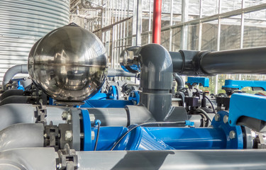 a range of plastic water pipes with large metal balls