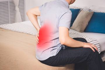 Back pain, kidney inflammation, man suffering from backache at home