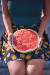 Girl holds watermelon on stadium