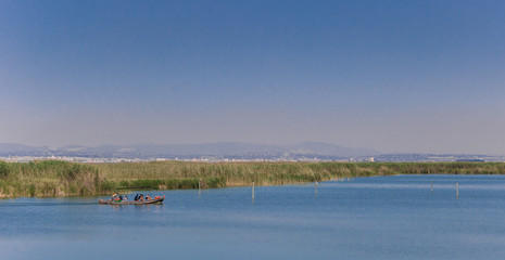 Tourists taking a tour on the lake in La Albufera National Park, Spain