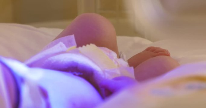 Small child in incubator , hospital Neonatology,Cared for by a doctor neonatologist and nurse. Medical devices cardiogram cannula tube.