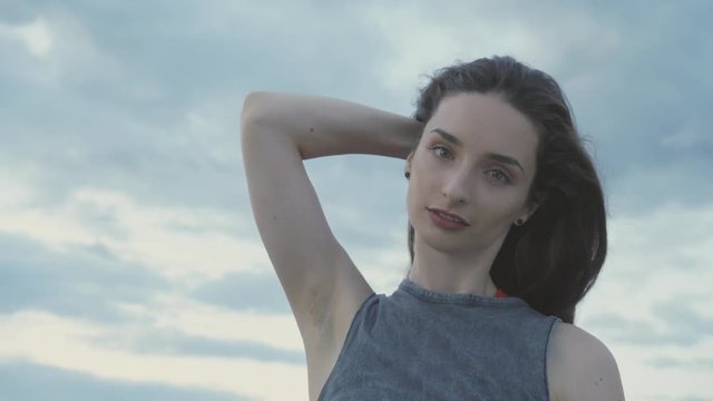 Young Girl dances slow and laughing into the camera