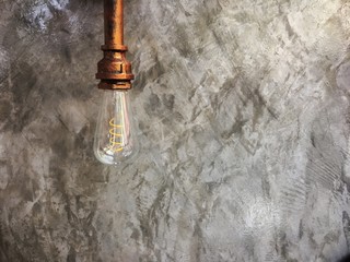 Vintage lighting lamp hang in front of cement wall at loft