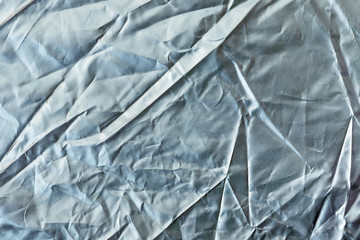 Top view of Cloth silver crumpled surface to make pattern and reflection. For use as background.