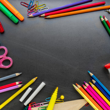 School supplies on blackboard background, top view. Back to school and Education concept.  Flat lay, copy space