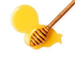 Honey dripping isolated on a white background. Natural bee Honey flowing drops, macro.