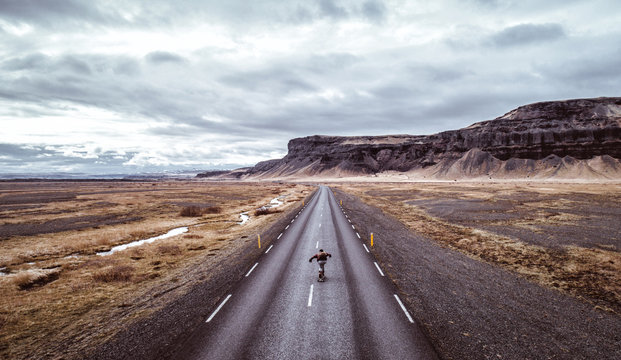 Man exploring beautiful destination with his longboard